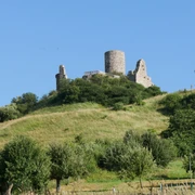 Burgruine Desenberg Burgruine Desenberg thront auf einem Hügel, umgeben von grünen Wiesen und vereinzelt stehenden Bäumen.