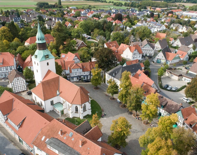 Ein malerisches Oval: Der Bad Essener Kirchplatz mit der 500 Jahre alten Kirche St. Nikolai, umstanden von Fachwerkhäusern