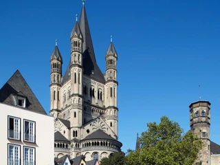 Cologne's old town with Groß St. Martin Ansicht der romanischen Kirche Groß St. Martin in Köln, umgeben von farbigen Altstadthäusern.View of the Romanesque church Groß St. Martin in Cologne, surrounded by colorful old town houses.