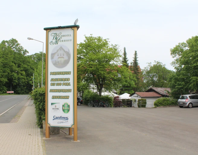 Waldhotel Moorhof Waldhotel Moorhof nahe einem ruhigen Parkplatz mit grünen Bäumen und einem großen Hotelschild.