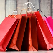 Composition with red paper shopping bags