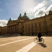 Bundesverwaltungsgericht Leipzig - Architektur in Leipzig Blick auf das Bundesverwaltungsgericht und davor fährt ein Fahrradfahrer, Architektur in Leipzig, Geschichte, Fahrradstadt