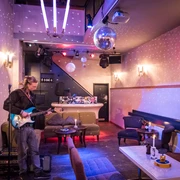 Oskar - Gastronomie in Leipzig Zusehen ist die kleine Bühne im Oskar mit einem Musiker mit E-Gitarre, Gastronomie, Bar, Restaurant, Freisitz
