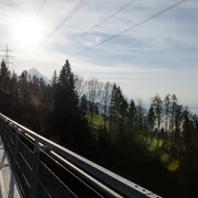 View of lake and mountains suspension bridge Leissigen