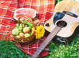 Picnic with watermelons, basket of fruits and guitar
