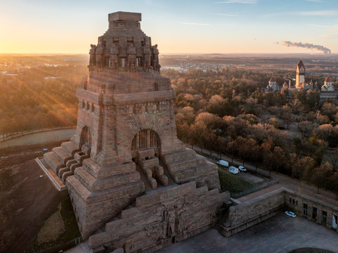 Blick von oben auf das Völkerschlachtdenkmal und den Südfriedhof mit dem markanten Krematorium während des Sonnenaufgangs, Kultur, Geschichte, Architektur