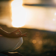 Sungazing. Woman Sun Gazing and Meditating by the Lake in Lotus Position.