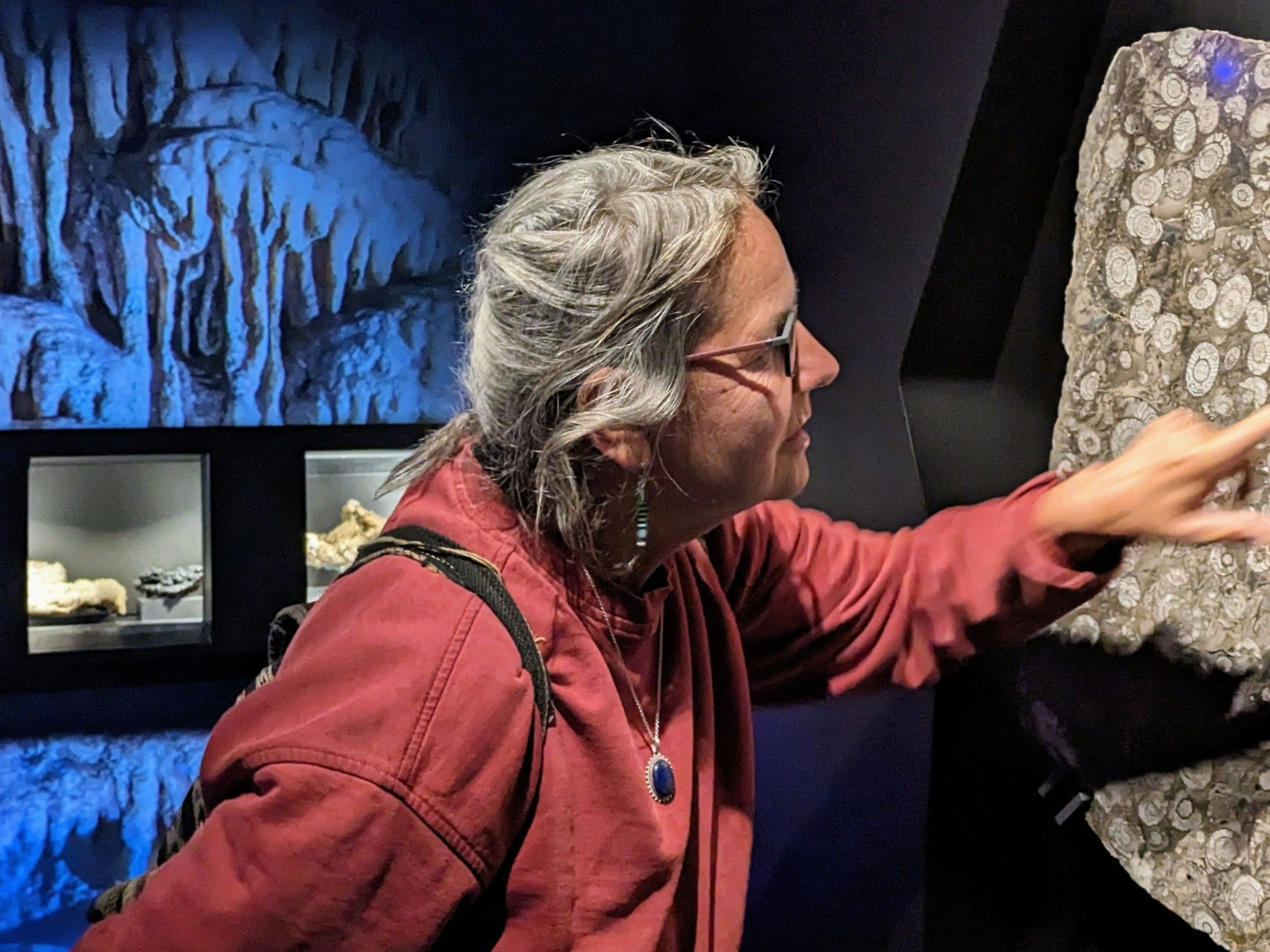 Besucherin an der Goniatitenwand Eingangsraum zu Höhle und archäologischem Museum HEZ