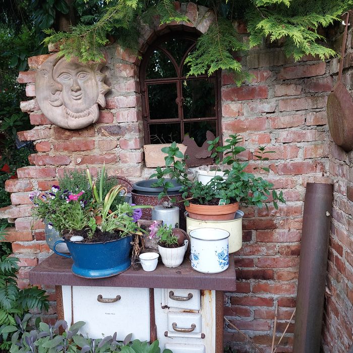 Mauer mit Ofen und Blumen