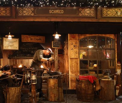 Blacksmith at the Christmas market in the old town of Cologne